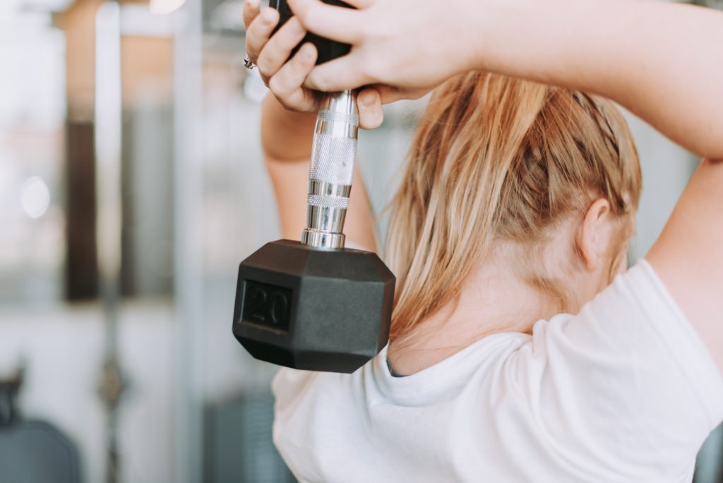 woman holding dumbbell