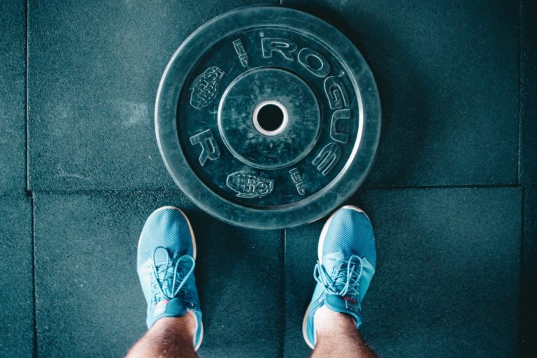 person standing next to weights